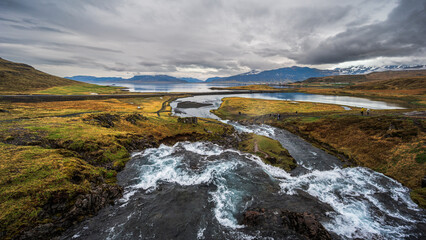 view of Mount Kirkjufell and Kirkjufellfoss during a rainy day in Snaefellness Peninsula, Iceland
