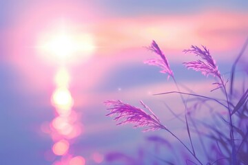 Obraz premium Silhouettes of Grass Blades Against a Pink and Purple Sunset Sky