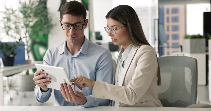 Client and sales manager met in office using tablet, review contract terms, company services or product features, benefits, planning marketing campaign, strategy. Briefing, brainstorm, joint project