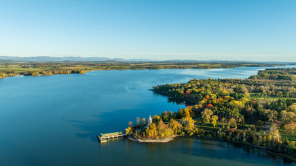 Aerial view of a scenic peninsula at Crown Point, surrounded by Lake Champlain’s calm waters,...