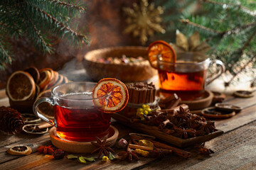 Christmas herbal tea with ingredients on a old wooden table.