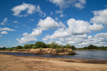 Beautiful summer landscape with clouds on the river.