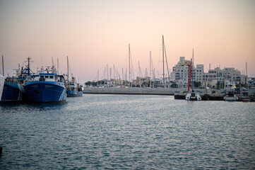 Naklejka premium The sunset at Limassol Old Port with fishing boats and beautiful buildings in Cyprus 
