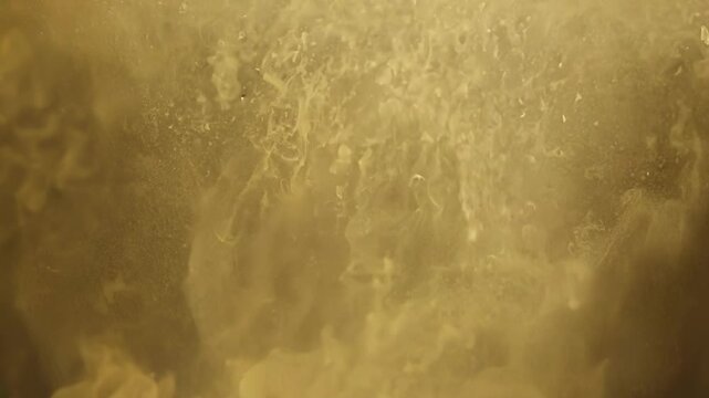 A close-up shot of a sandy golden surface with fine grains in focus, evoking textures of nature and earth. Ideal for backgrounds or earthy themes.