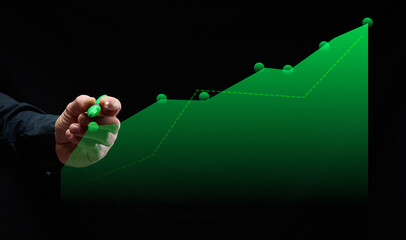Graph with growing indicators and male hand with green marker on black background