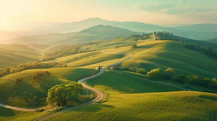 Naklejka premium Idyllic countryside with a winding road through rolling hills