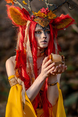 Deer girl in the autumn forest
