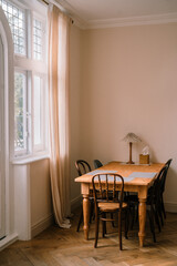 Spacious dining room with wooden farmhouse table in vintage style