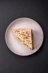 Sandwich with toast bread, meat, tomatoes, cheese, sauce, salt and spices