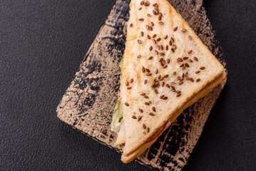 Sandwich with toast bread, meat, tomatoes, cheese, sauce, salt and spices