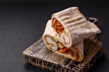 Roll with pita, meat, tomatoes, cheese, sauce, salt and spices