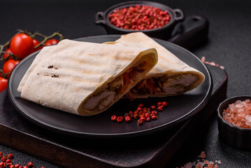 Roll with pita, meat, tomatoes, cheese, sauce, salt and spices