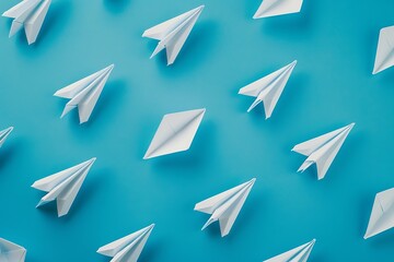 Fototapeta premium Colorful paper airplanes on blue background. Minimal creative concept.