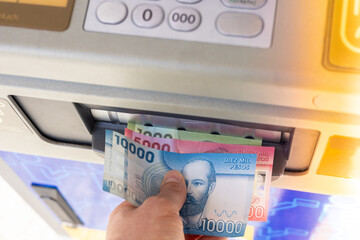 Chilean pesos banknotes withdrawn from ATM, financial concept, Chile money