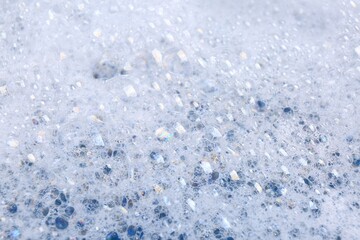 Detergent foam as background, closeup. Hand washing laundry