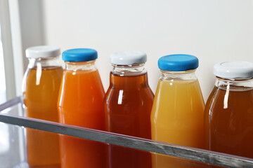 Many bottles of juice in refrigerator, closeup