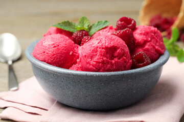 Delicious raspberry sorbet, fresh berries and mint in bowl on light table, closeup