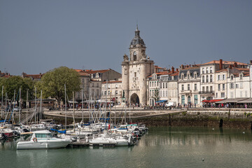 Fototapeta premium Sailing boats moored in the port of La Rochelle with the city in the background