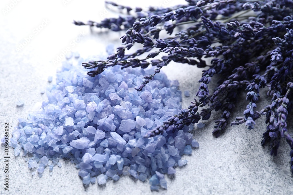 Wall mural Natural sea salt and lavender flowers on grey table, closeup