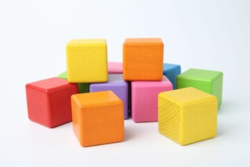 Many wooden colorful cubes on white background