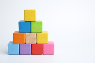 Obraz premium Pyramid of colorful cubes on white background, space for text