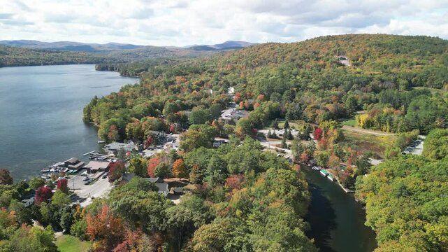 Drone aerial over Holderness, New Hampshire in the fall season with fall foliage on trees in Lake Squam