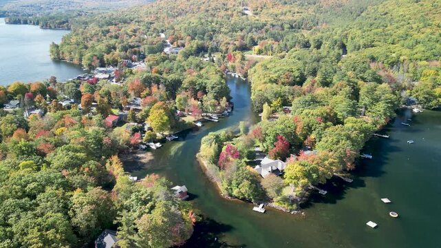 Drone aerial over Holderness, New Hampshire in the fall season with fall foliage on trees in Lake Squam