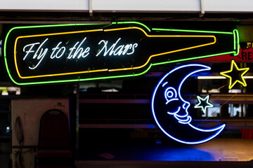 Neon bar sign that says "Fly to the Mars" instead of "Fly to the Moon"