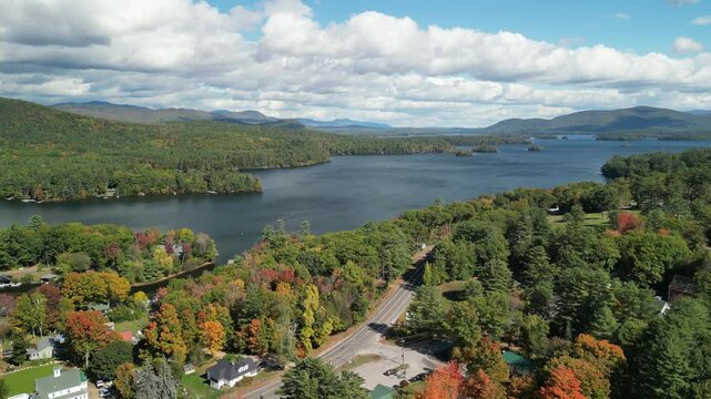 Drone aerial over Holderness, New Hampshire in the fall season with fall foliage on trees in Lake Squam