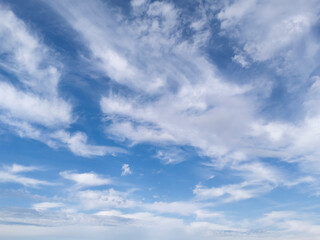 A stunning blue sky filled with wispy white clouds, creating a serene and peaceful atmosphere perfect for relaxation or inspiration.