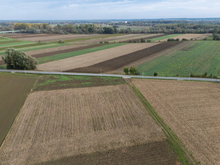 Aerial view of agricultural fields showing different crops and textures in the landscape. Green and brown patches create a harmonious rural scene.