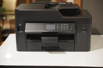 front view, antique black plastic printer on white table, office background, technology, object, office, decor, comfortable, business, copy space