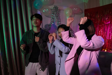 A group of people are dancing and playing with balloons