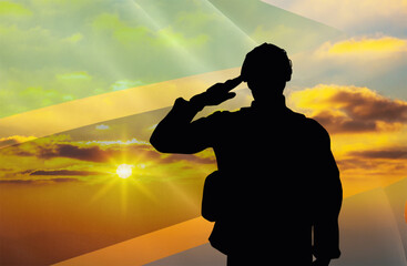 Silhouettes of soldiers with a background of the Tanzania flag and a sunset or sunrise. Concept of national holidays. Commemoration Day.