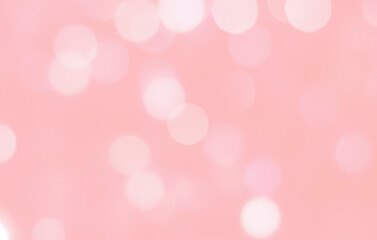 Defocused bokeh background in pastel colors with copy space. Defocused abstract background with pink and white circles on light pink background.
