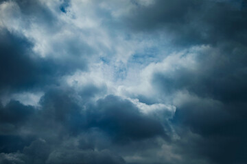 Dramatic clouds gather in a dark sky, hinting at an incoming storm.