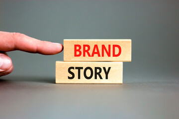 Brand story branding symbol. Concept words Brand story on beautiful wooden blocks. Beautiful grey background. Businessman hand. Business brand story branding concept. Copy space.