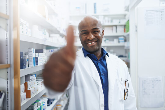 Pharmacy, doctor and black man in portrait for thumbs up, approval and thank you for customer service. Healthcare, pharmacist and smile with yes for medicine, prescription and success for promotion - Powered by Adobe