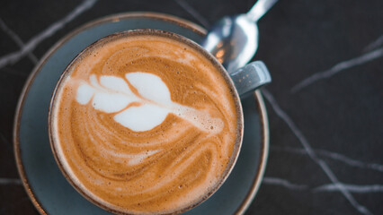 Close-up of a latte with a beautiful pattern, showcasing creamy coffee art