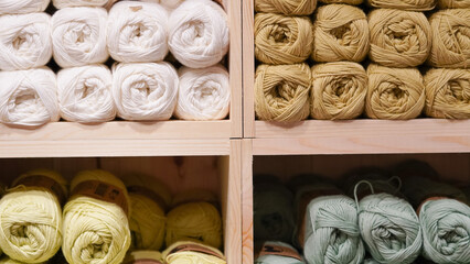 Colorful yarn threads displayed on a shop window, inviting creativity and warmth