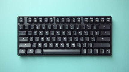 A close-up view of a sleek black computer keyboard on a turquoise surface highlighting its simple, elegant design