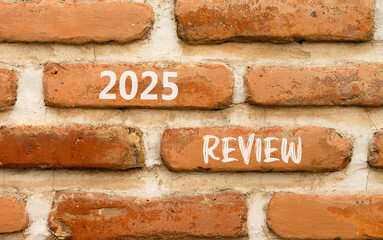 Planning 2025 review new year symbol. Concept words 2025 Review on beautiful brown brick wall. Beautiful brown brick wall background. Business 2025 review new year concept. Copy space.