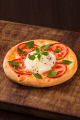 Delicious Caprese Pizza with Fresh Mozzarella and Basil Leaves