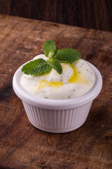 Delicious Creamy Yogurt Sauce in White Bowl with Fresh Mint Garnish