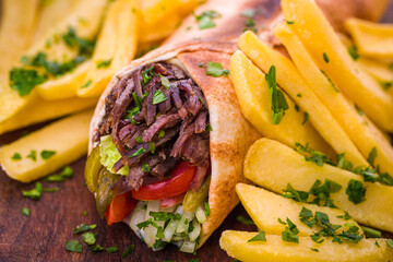 Delicious Shawarma Wrap with Crispy Fries and Fresh Herbs