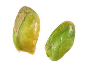 Halves of peeled pistachio nut isolated on white