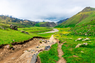 A dramatic scenic landscape with a dirt road descending into the Emmanuel Valley in the Elbrus...