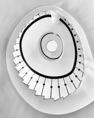 A spiral staircase viewed from below. AI.