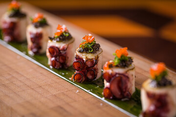 Gourmet Octopus Sushi Rolls with Decor in Restaurant Setting