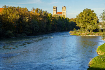 The Isar in Munich, Bavaria, Germany. View of the striking towers of the neo-Romanesque church of...